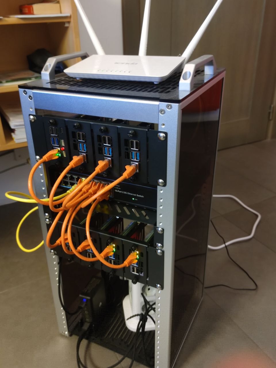 photo of an 8 Raspberry PI cluster mouted in a small rack connected via a switch
